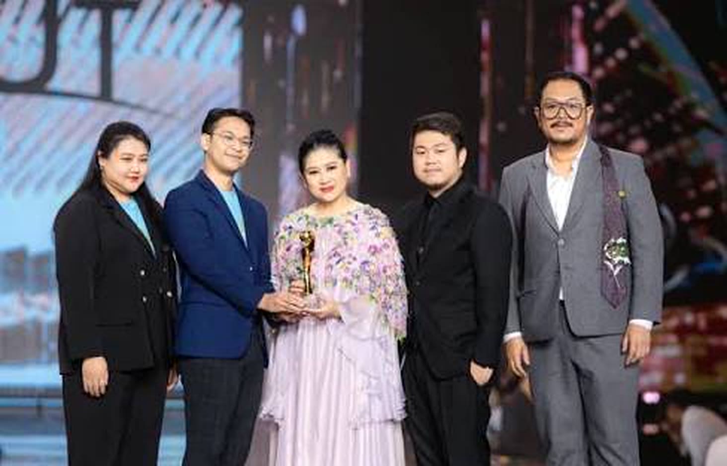 An award-stage moment with collaborators